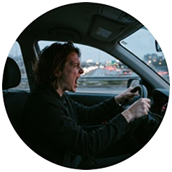 A person yelling in their car while stuck in traffic