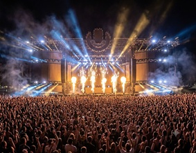 Fireworks exploding over a festival mainstage