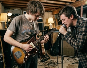 A cozy, cluttered basement band practice space
