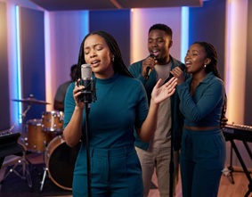 A modern stage setup with a solo gospel singer