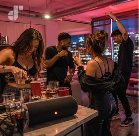 Friends hyping each other up and holding red cups in a pre-game setting