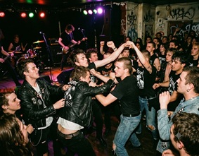 Leather jackets and spiked hair in a crowded punk show