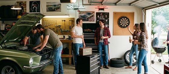 Friends hanging out and drinking beer in a garage