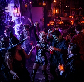 A glowing jack-o-lantern surrounded by party lights