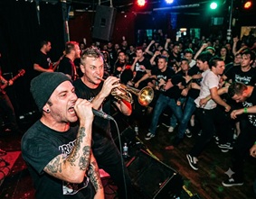 A chaotic mosh pit at an underground music venue
