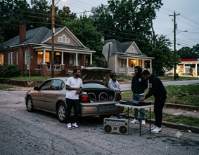 A hazy, neon-lit urban street corner in Atlanta